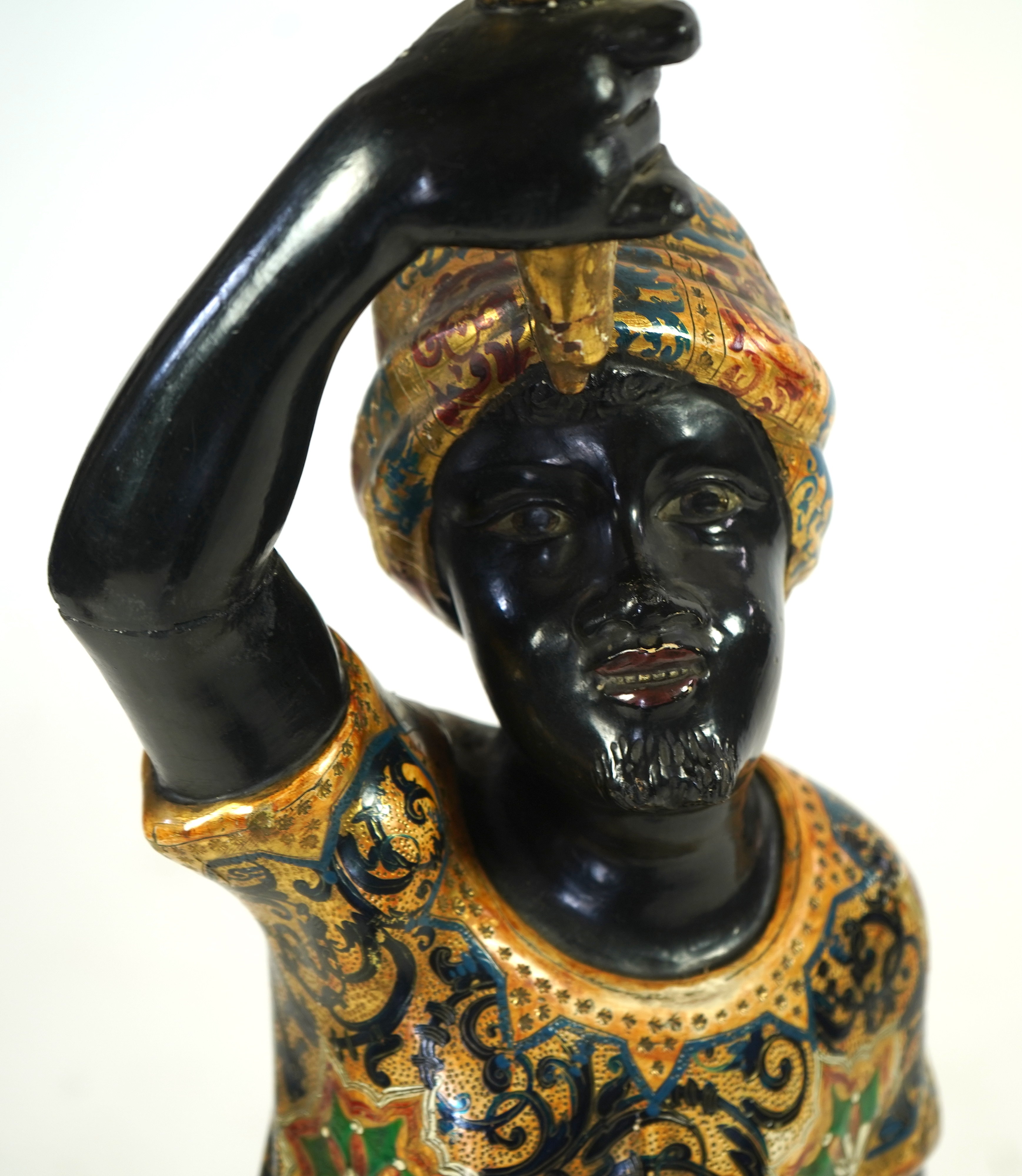 A 19th century Italian carved wood and composition polychrome painted blackamoor torchere
